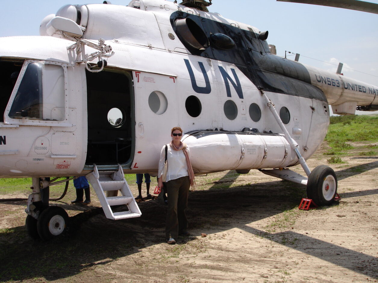 Susannah Friedman in front of a UN helicopter